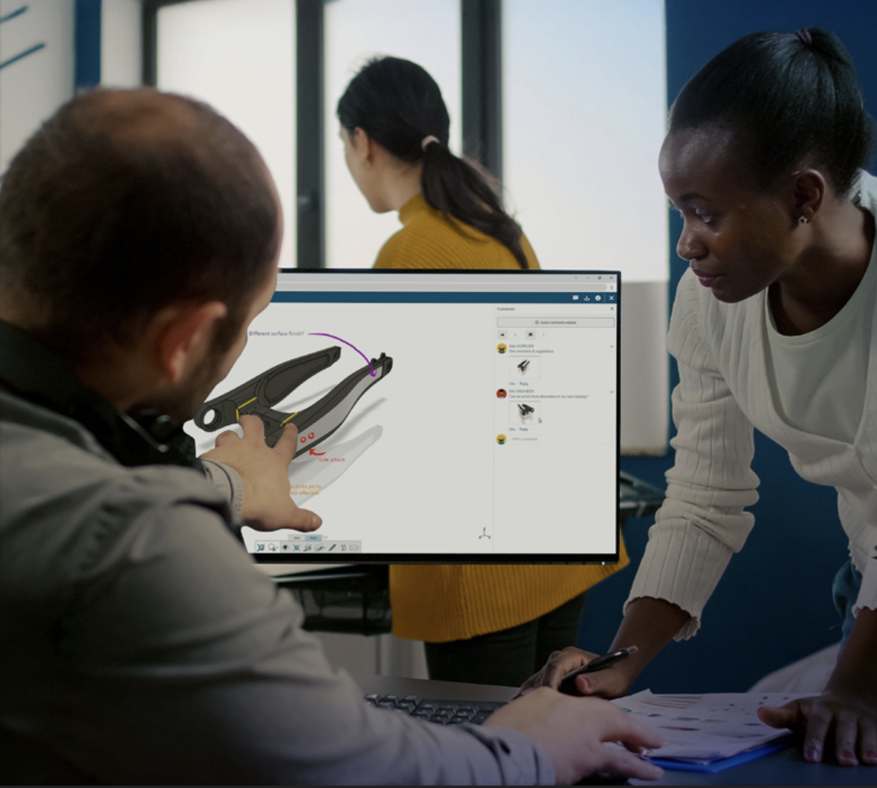 Engineers collaborating on a SOLIDWORKS model